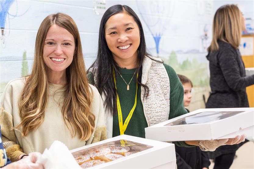 Students and their families enjoy donuts